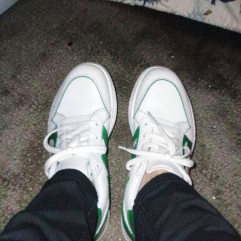 Sneakers + skateboard prop + street backdrop — reference 1